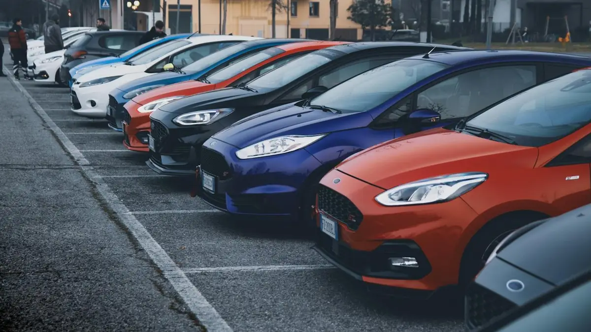 A row of rental vehicles in a car park